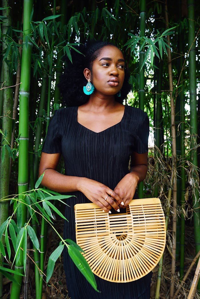 Photo of Woman Wearing Black Dress Near Bamboo Trees